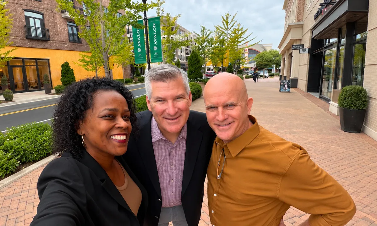 Three colleagues taking a selfie together outside the office