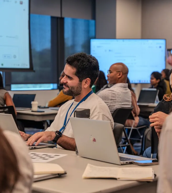 Colleagues working at laptops in a meeting room