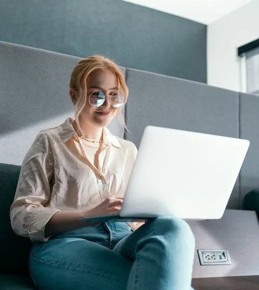 A woman working on a laptop in a quiet booth